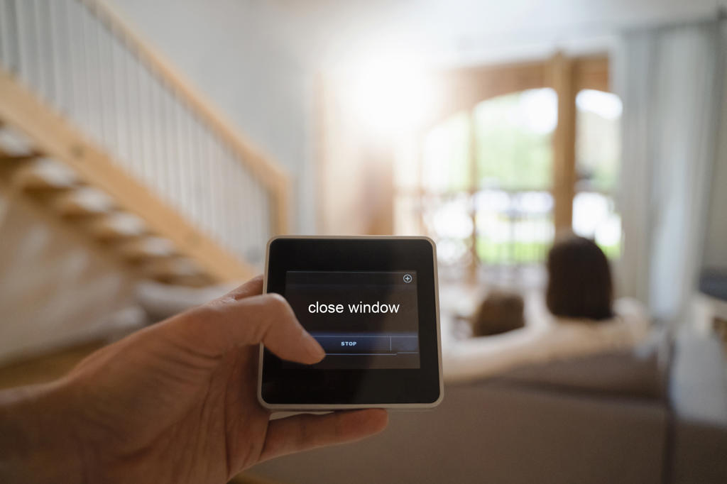 Woman using smart home automation device at home