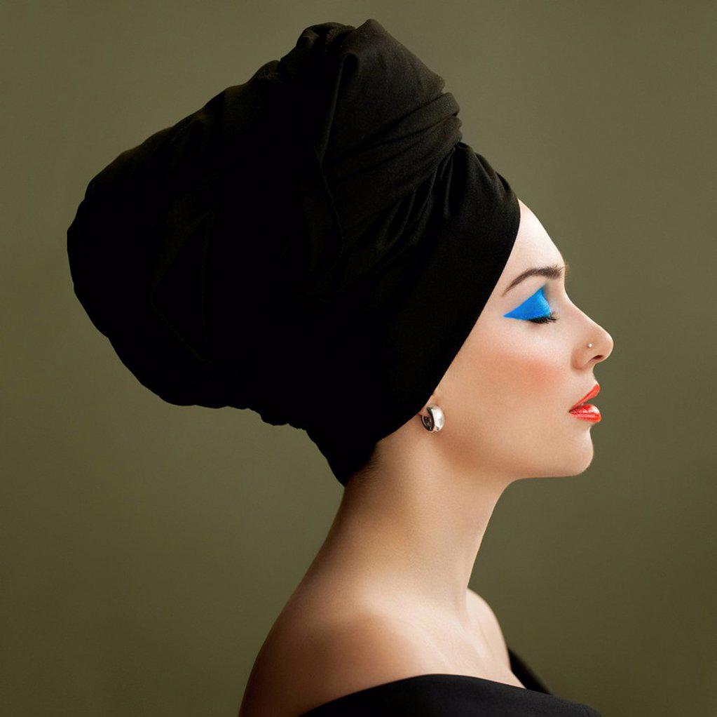 Woman with eyes closed wearing black turban