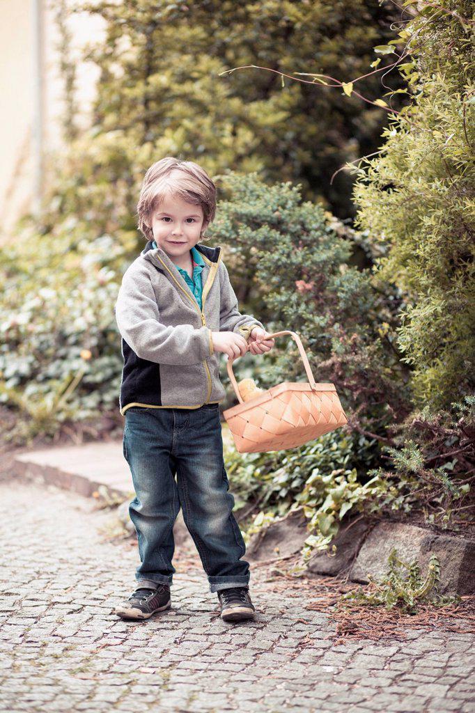 Little boy with basket on the move