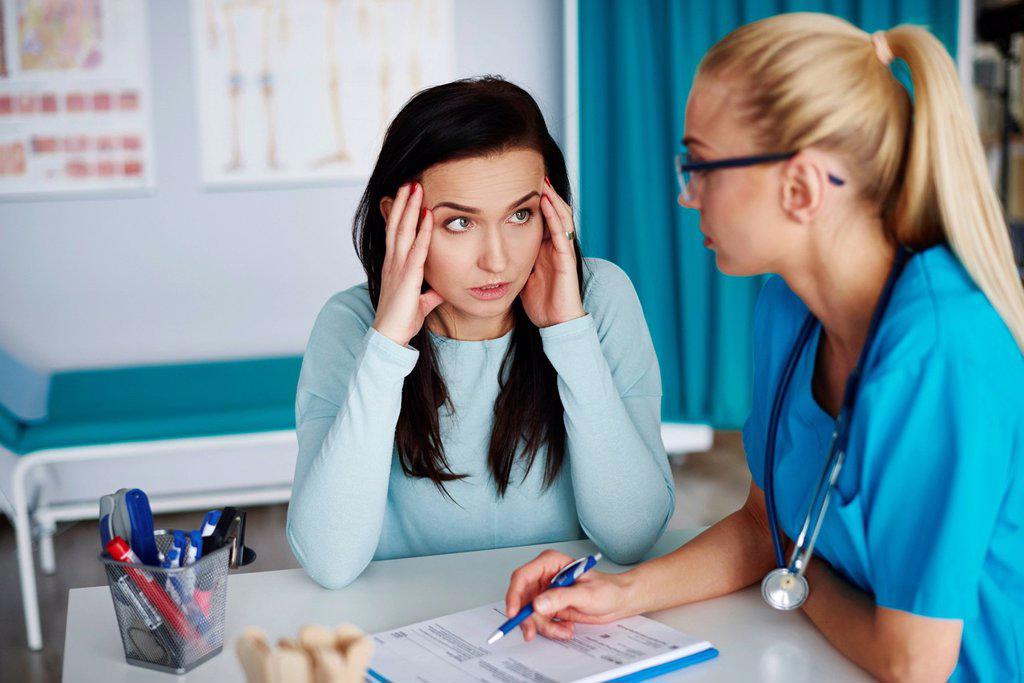 Worried woman talking to doctor in medical practice