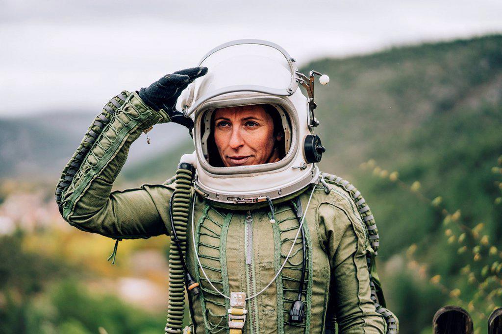 Portrait of woman in space suit exploring nature