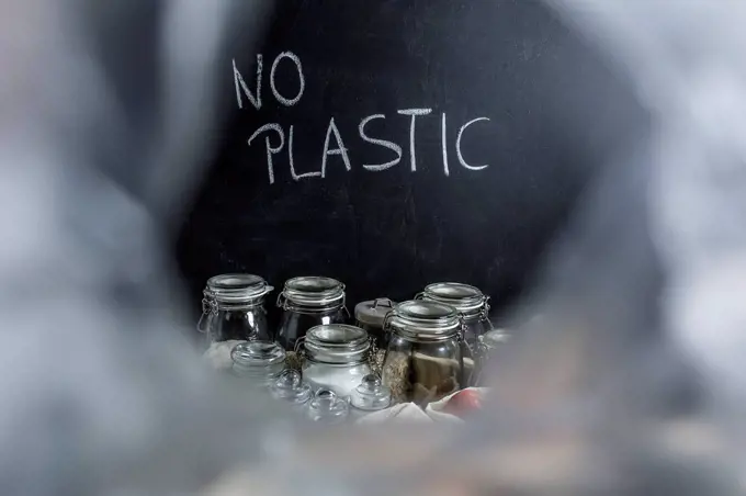 Groceries in jars for waste prevention and writing 'no plastic'