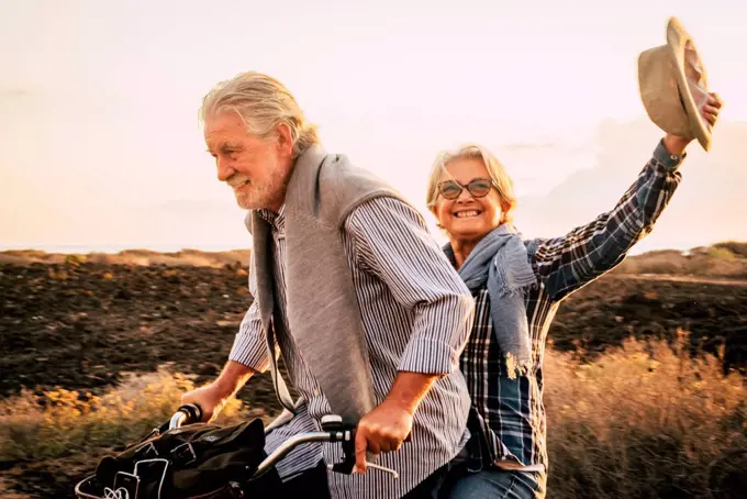 Happy active senior couple on bicycle, Tenerife