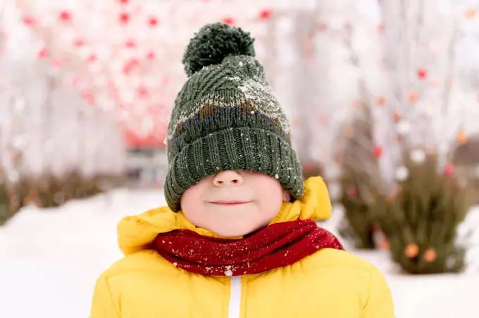 Boy hiding his face with knit hat