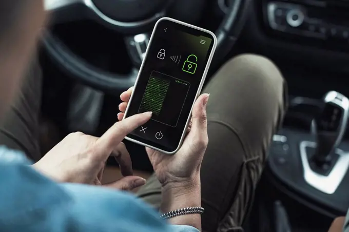 Woman unlocking data lock on smart phone in car