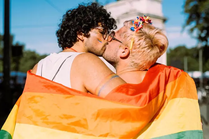 Gay couple kissing on sunny day