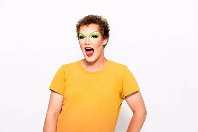 Man with make-up on face shouting against white background