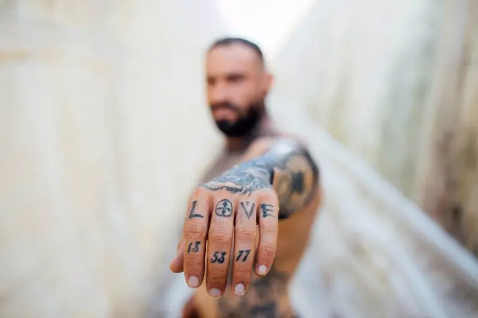 Man showing tattooed hand