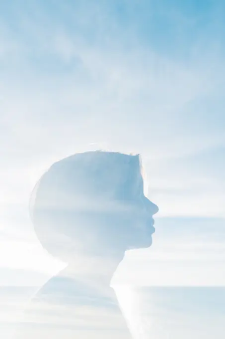 Double exposure of woman with sky