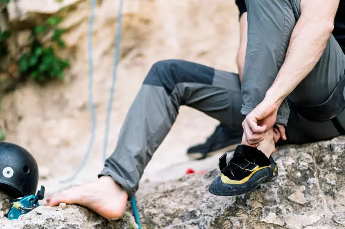 Man wearing boot before going for rock climbing