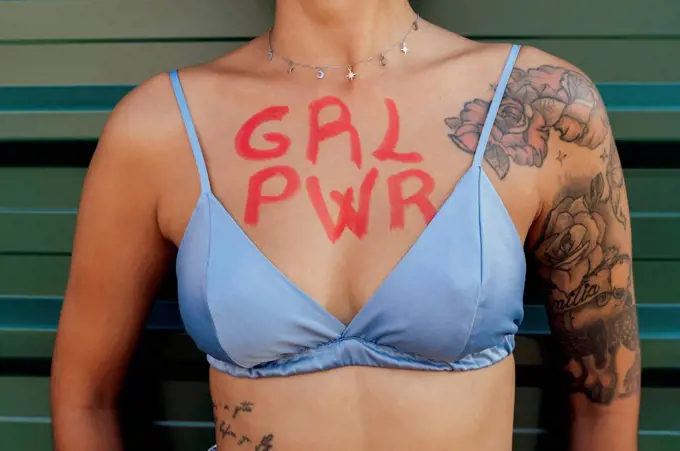 Woman with girl power text on chest