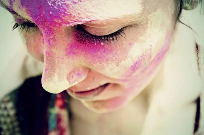 India, Ahmedabad, Young woman celebrating holi festival with powder paint