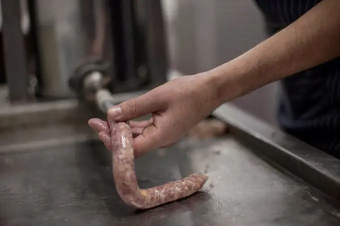 Butcher making sausages in butchery