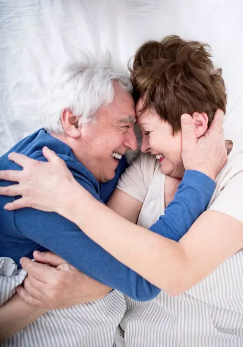 Senior couple having fun in bed