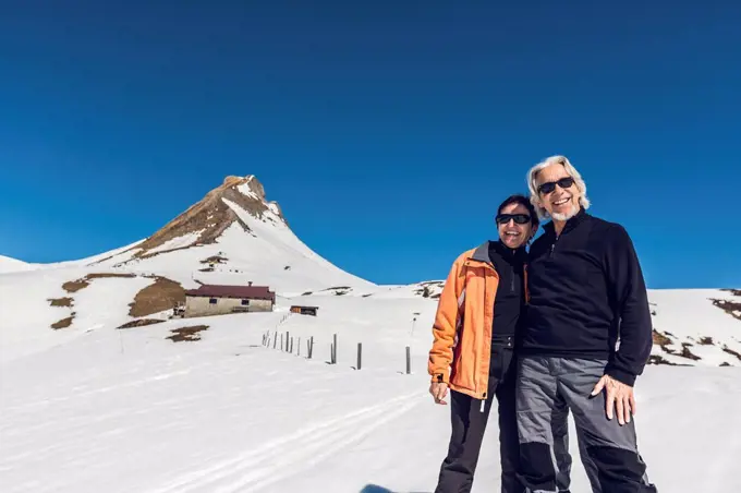 Austria, Damuels, portrait of happy senior couple in winter landscape
