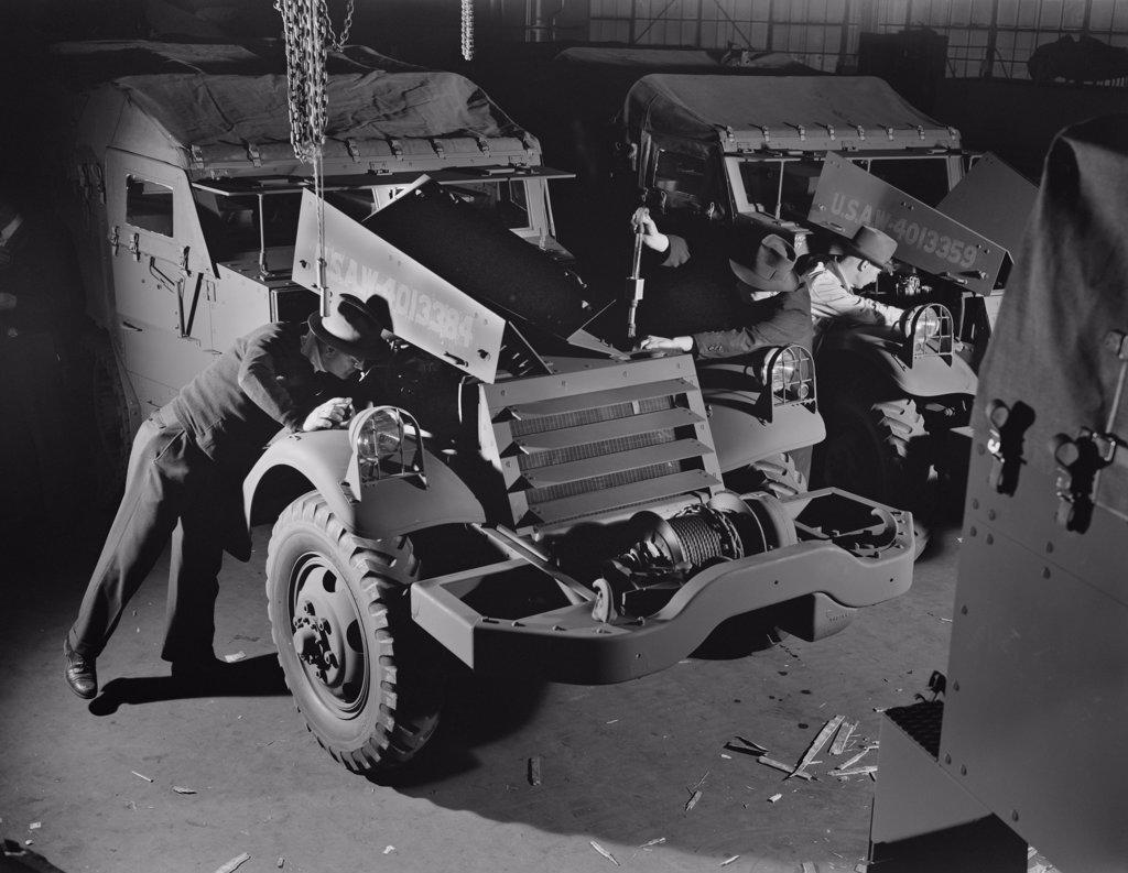 Army's Half-Track Scout Cars Being Inspected before Delivery from Factory Converted to War Production, White Motor Company, Cleveland, Ohio, USA, Alfred T. Palmer for Office of War Information, December 1941