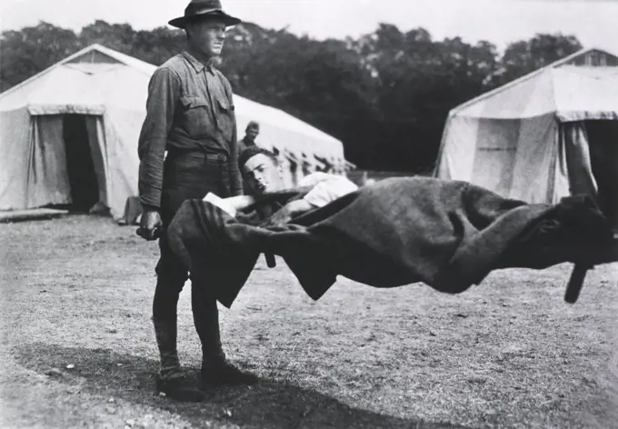 Patient being transported on Stretcher, Two Tents in background, part of Red Cross Mobile Hospital Number 5 which was set up on a former race track, Auteuil, France, 1914-1918