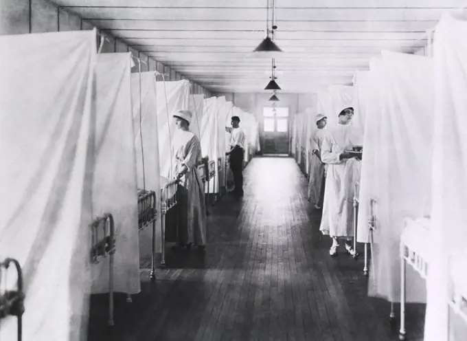 Nurses and Orderlies standing at foot of Beds separated by Sheets, Influenza Ward, U.S. Army, Walter Reed General Hospital, Washington, D.C., USA, 1918