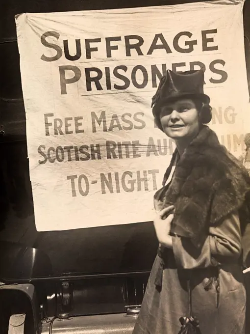 Lucy Branham, American Suffragist, standing in front of banner, "Suffrage Prisoners", National Woman's Party, March 1919