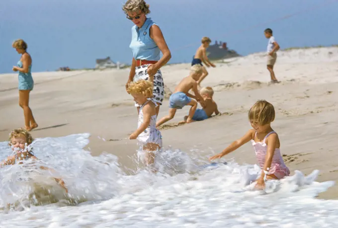 Children playing at Hamptons Beach, Long Island, New York, USA, Toni Frissell Collection, August 1955