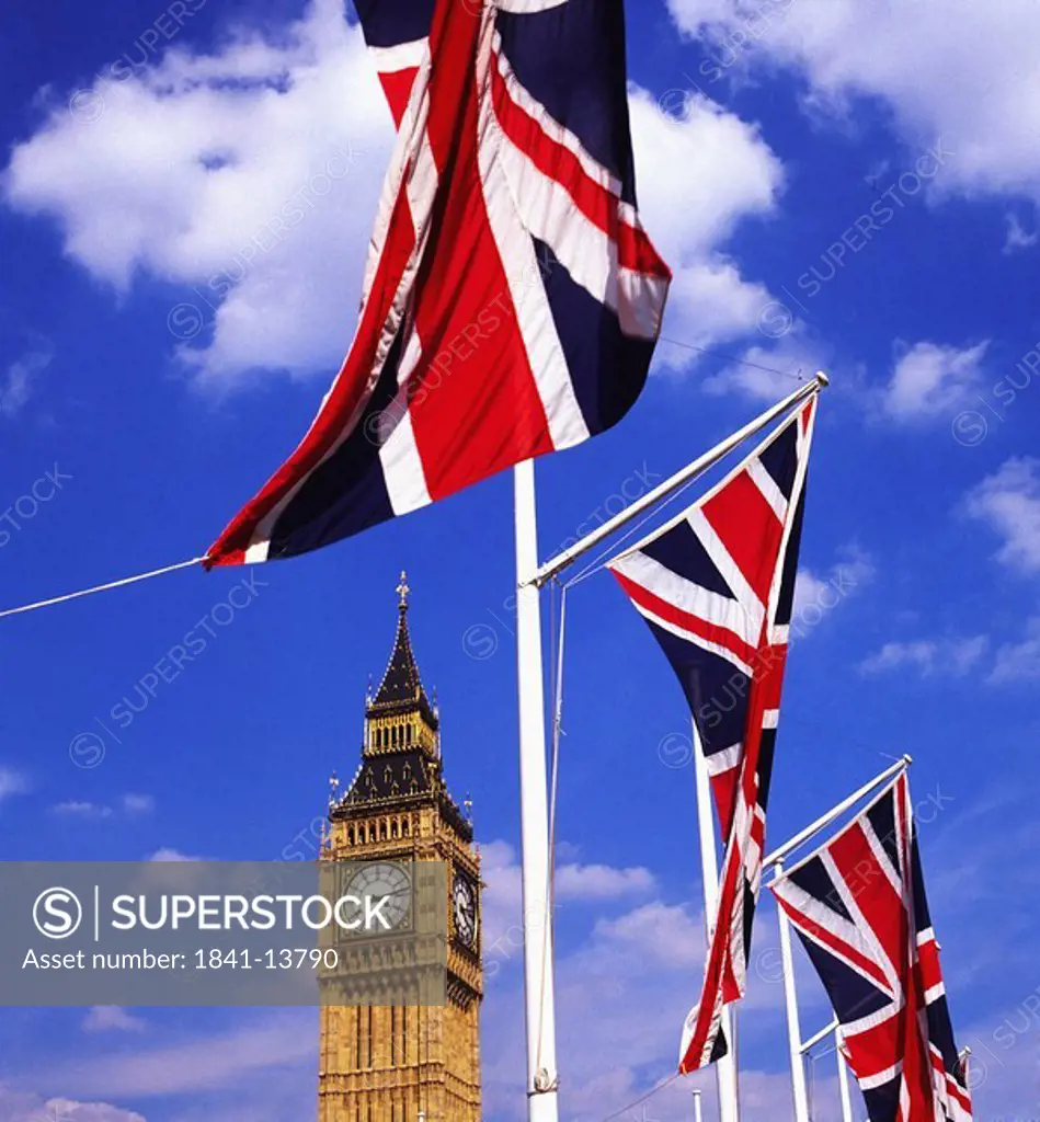 Low angle view of clock tower and flags of France, London, France, Europe