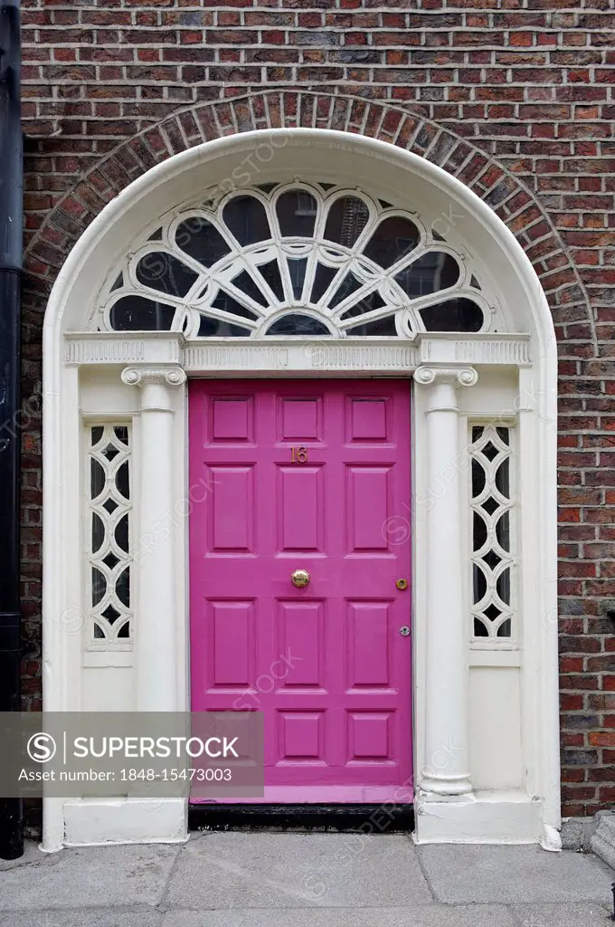 Pink front door of a terraced house near Merrion Park, Dublin, Republic of Ireland, Europe
