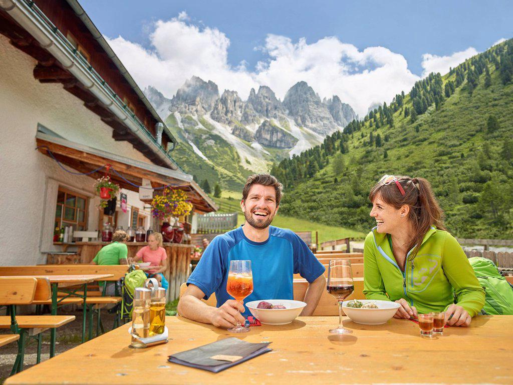 Hikers taking break at mountain hut, Kalkkögel, Tyrol, Austria