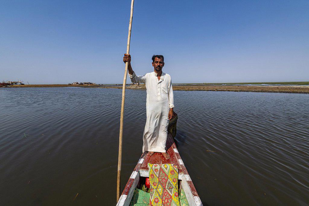 Marsh arab on his boat, Mesopotamian Marshes, Ahwar of southern Iraq, Unesco site, Iraq, Asia