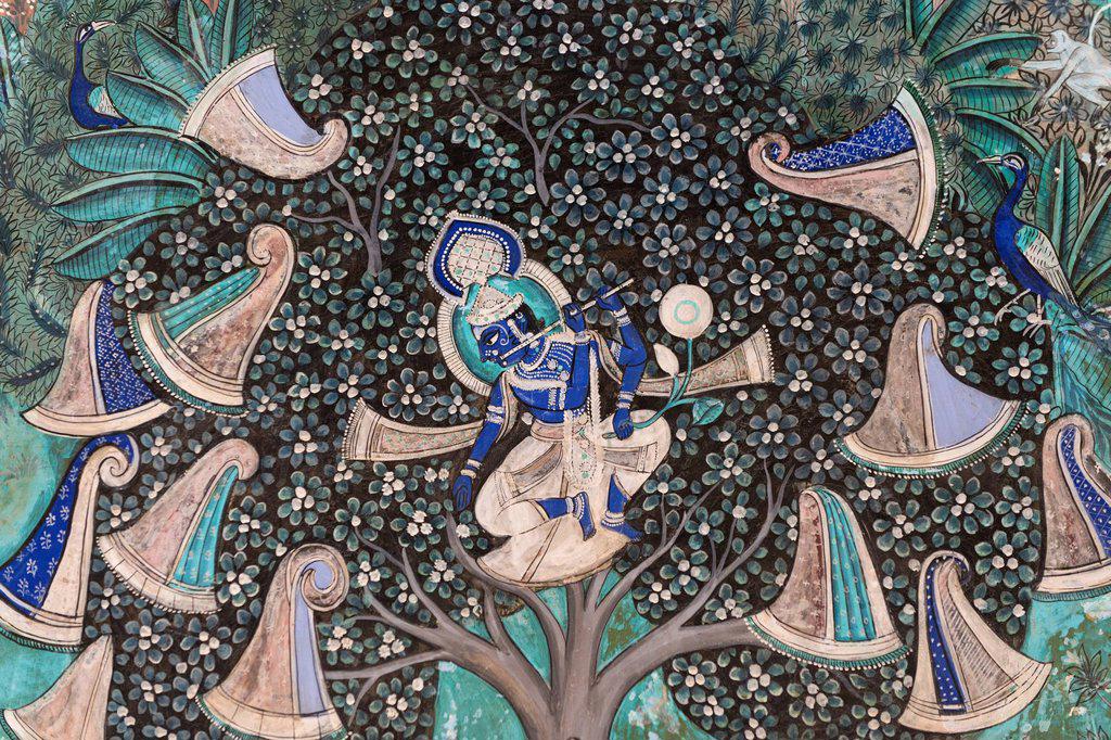 Pastoral god Krishna playing on his flute after he has hidden the clothes of the shepherd girls in a tree, wall painting or fresco painted with natura...