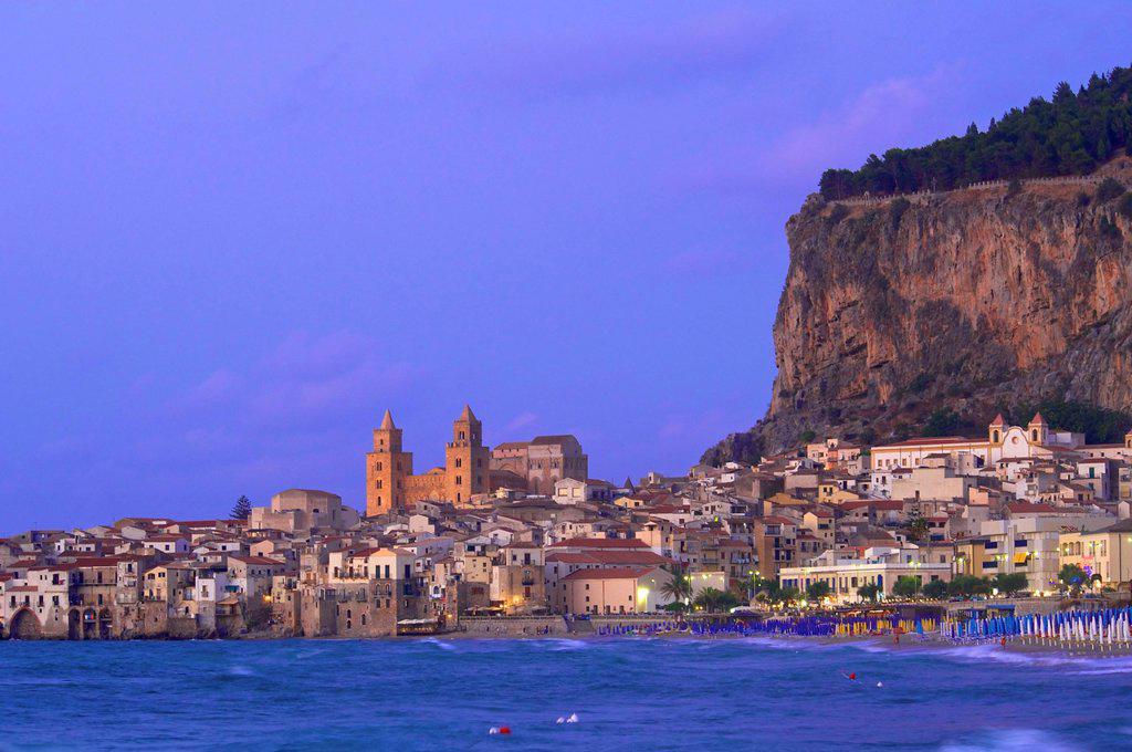 Coast, historic town centre and Rocca di Cefalu at dusk, Cefalù ...