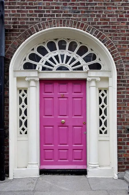Pink front door of a terraced house near Merrion Park, Dublin, Republic of Ireland, Europe