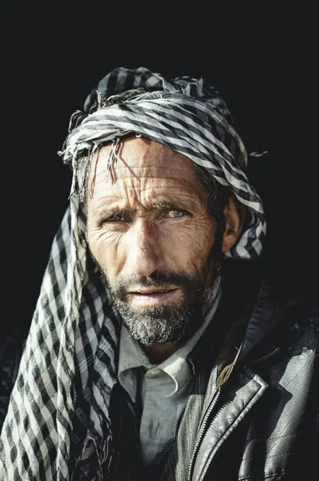 Said, porter and caravan leader with black leather jacket and black and white patterned Kufiya Wakhan corridor, Saradh-e-Broghil, Afghanistan, Asia