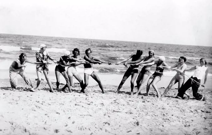 Group with bathers on the beach, funny, laughing, summer holidays, holiday, joie de vivre, rope pulling, competition, about 1930s, Baltic Sea, Usedom,...