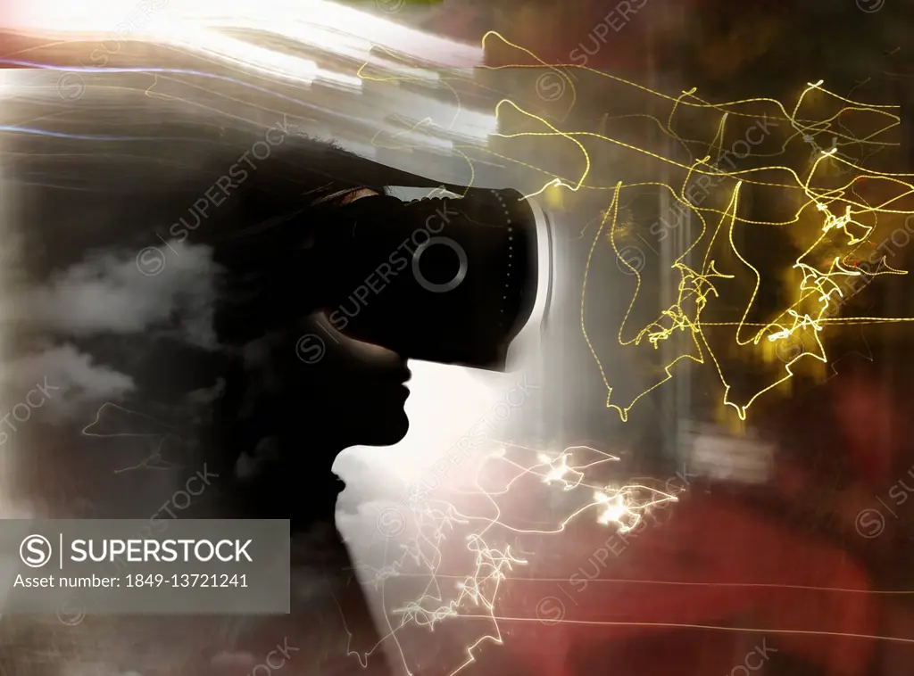 Man wearing virtual reality headset among light trails