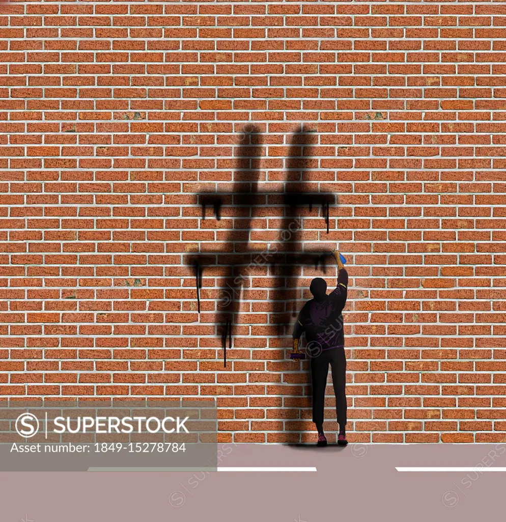 Graffiti artist spraying hashtag symbol on wall