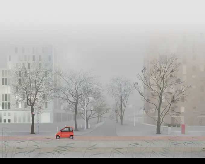 Man driving small car in empty foggy city street