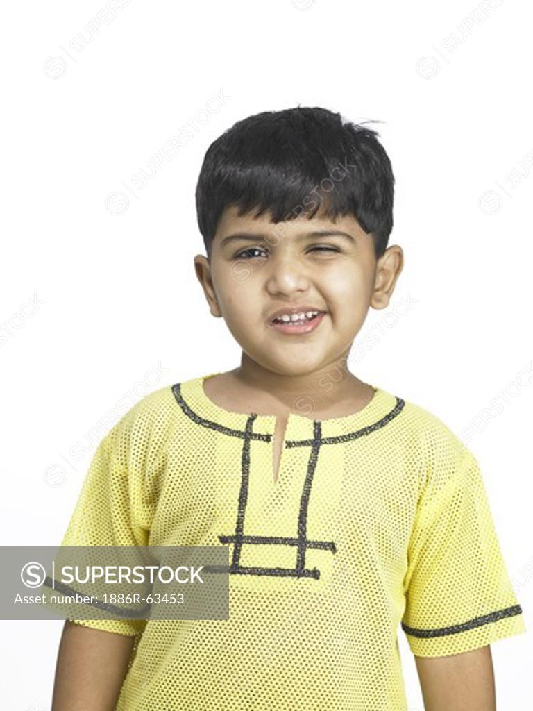 South Asian Indian boy making funny face in nursery school MR winking -  SuperStock