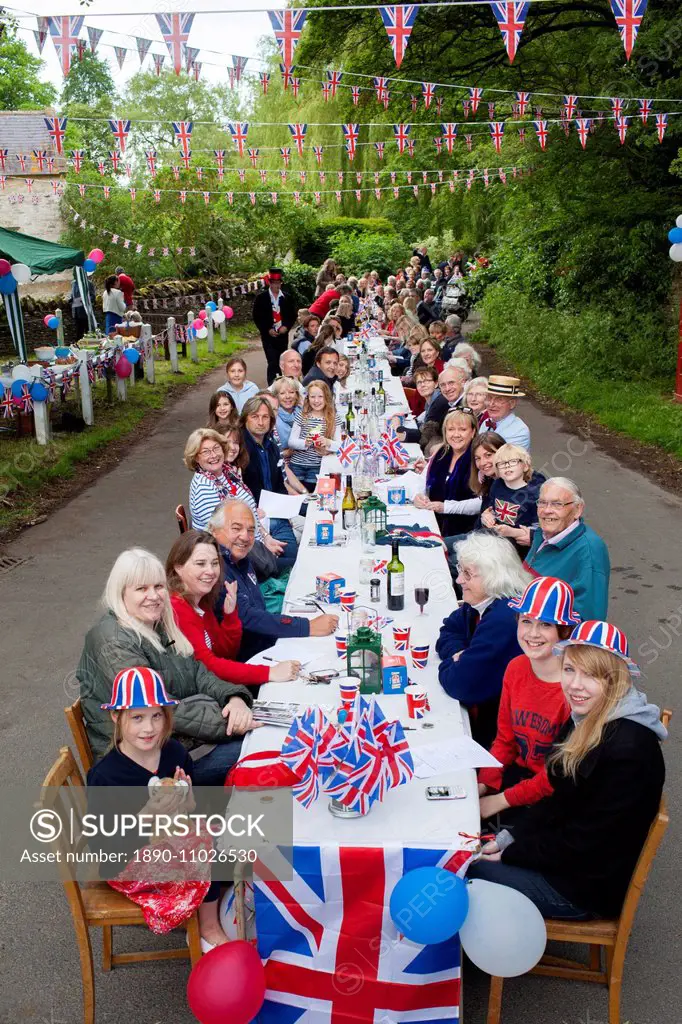 Street party with Union Jack flags and bunting to celebrate Queen's Diamond Jubilee at Swinbrook in The Cotswolds, UK