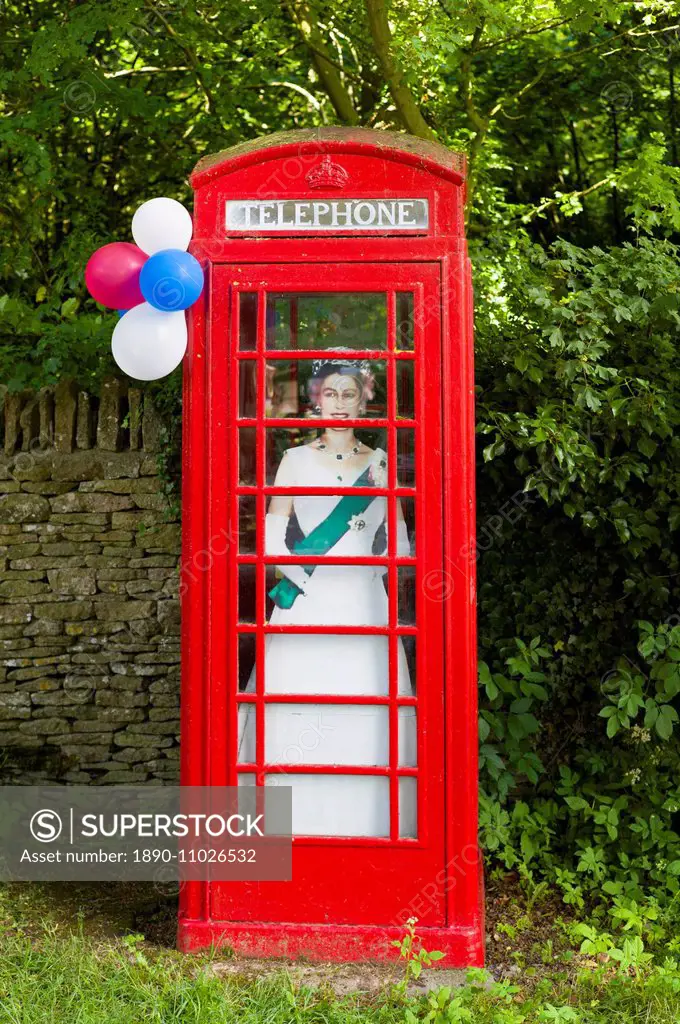 Cutout image of Queen Elizabeth II in phonebox at street party to celebrate the Diamond Jubilee in Swinbrook in the Cotswolds, UK