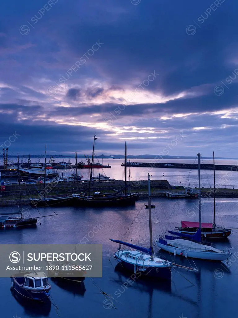 Spring twilight across the harbour at the fishing port of Newlyn, Cornwall, England, United Kingdom, Europe
