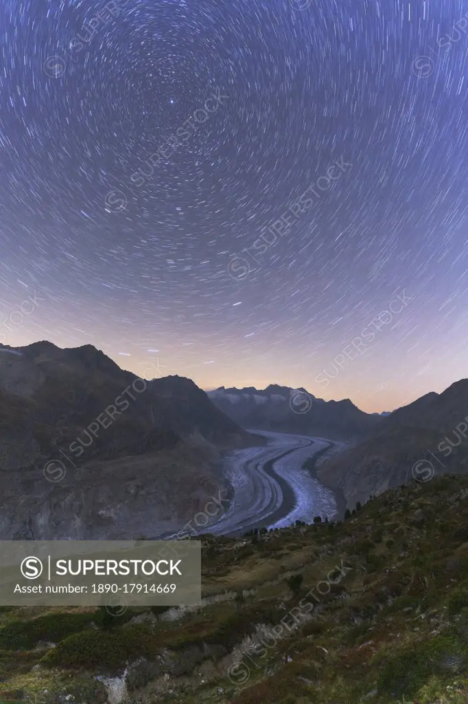 Star trail in the night sky above Aletsch Glacier, Bernese Alps, Valais canton, Switzerland, Europe