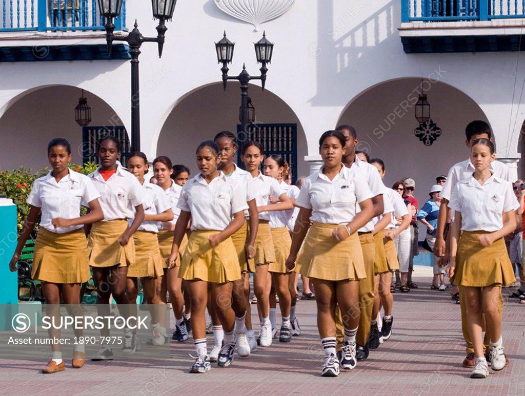 Young girls in uniforms marching at a school festival