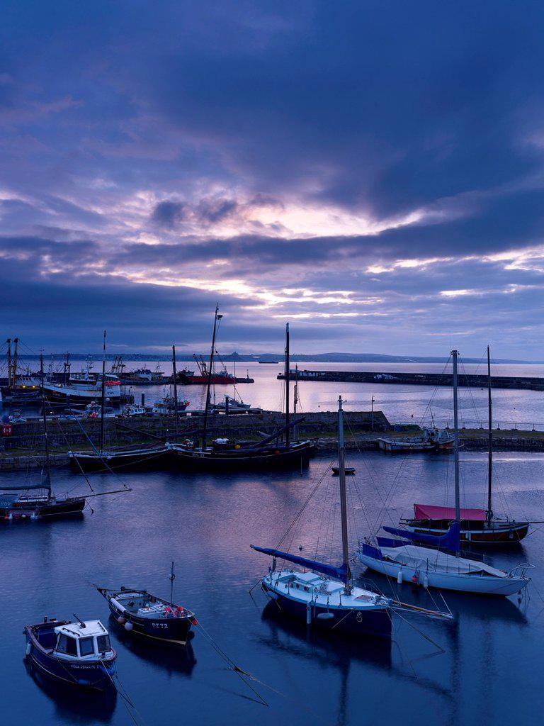 Spring twilight across the harbour at the fishing port of Newlyn, Cornwall, England, United Kingdom, Europe
