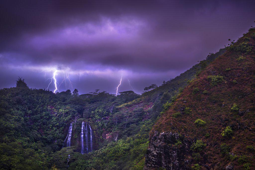 Lightning flashes behind Opekaa Falls, Kauai, Hawaii, United States of America, Pacific
