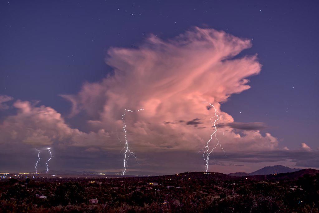 Isolated storm cell passing over the Prescott area of Arizona in the distance with the town of Chhino Valley in the foreground, Arizona, United States of America, North America