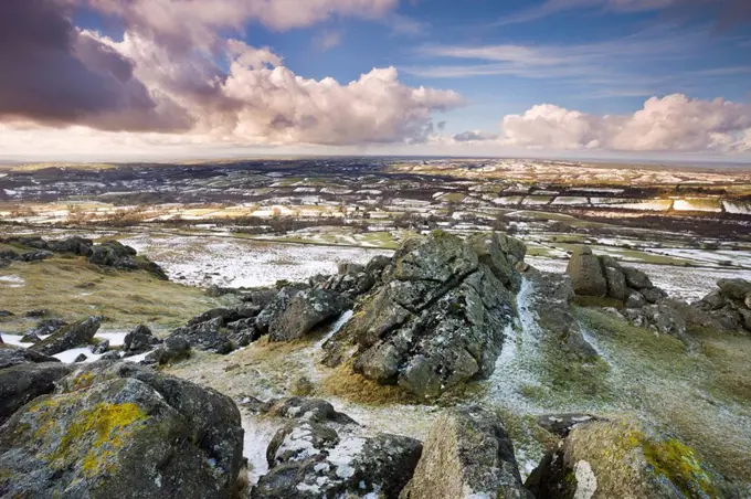 Sourton Tor backed by snow dusted countryside in winter, Dartmoor National Park, Devon, England, United Kingdom, Europe