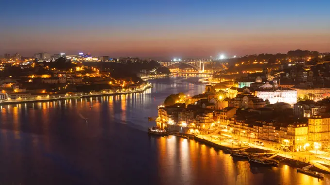 Skyline of the historic city of Porto at night with the bridge Ponte de Arrabida in the background, Oporto, Portugal, Europe