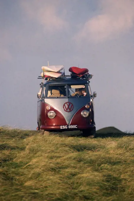 VW Camper Van with surf boards on roof