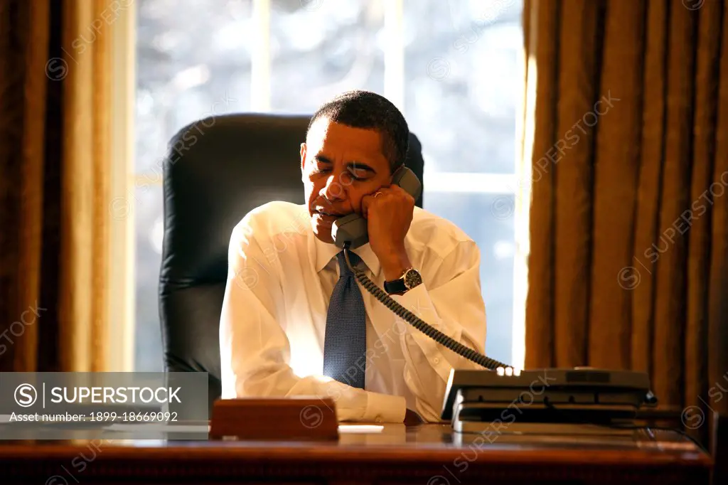 President Barack Obama speaks with a  foreign leader in the Oval Office on his first day in office 1/21/09.  .