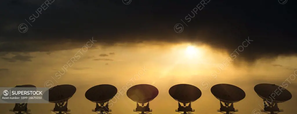 Large radio telescopes searching the skies at sunrise on a clear day 3D Rendering